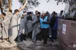 Greece. Recently arrived Afghan asylum seekers wait to board a UNHCR b...