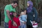 Syrian refugee parents Afeesh and Rasha hug their daughters shortly af...