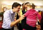Syrian refugees are greeted by Canada's Prime Minister Justin Trudeau ...