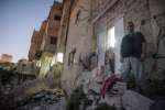 Syrian refugee Namr stands outside the apartment he rents in Amman, Jo...