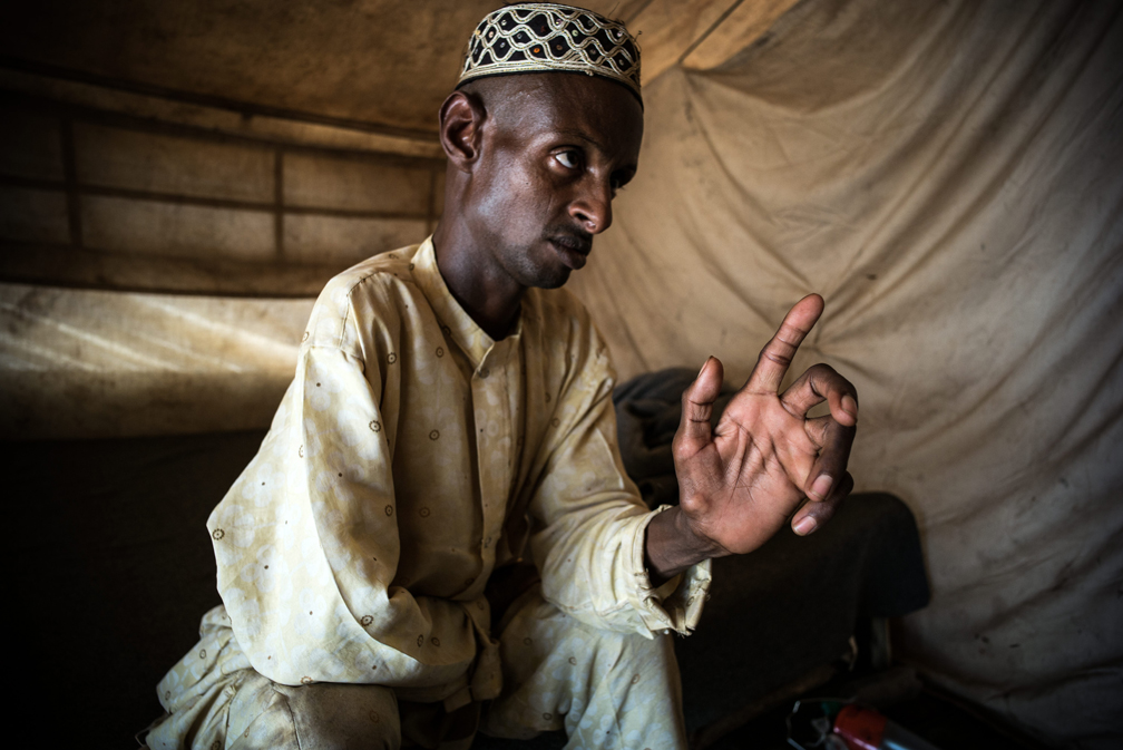 Abdu, seated in his tent in Gado, Cameroon, tells a visitor about his troubled marriage. The day before, he beat his 14-year-old wife because he was unhappy with her behaviour. UNHCR / Olivier Laban-Mattei