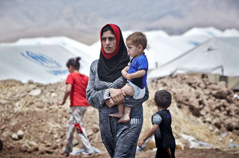 An Iraqi woman from Mosul carries her son at the Garmava transit [&hellip;]