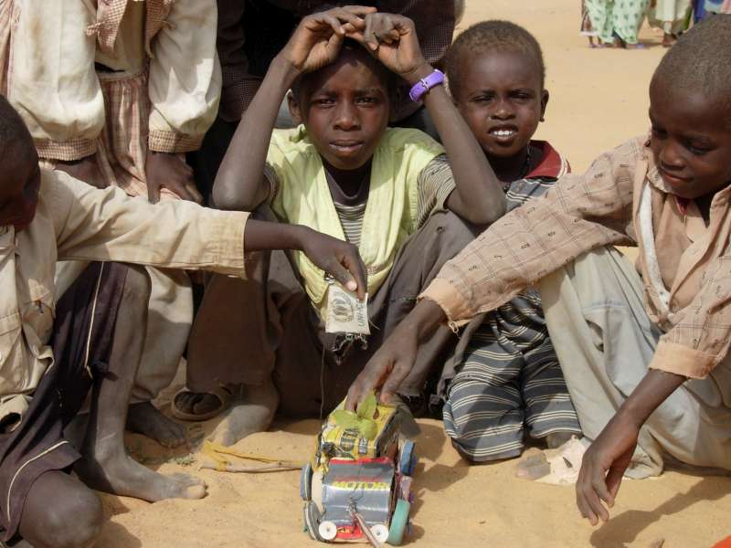 A Sudanese refugee boy with a makeshift toy truck he has built [&hellip;]
