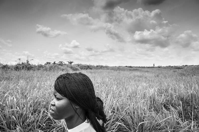 Edwidge walks through tall grass near the plot of land that she [&hellip;]