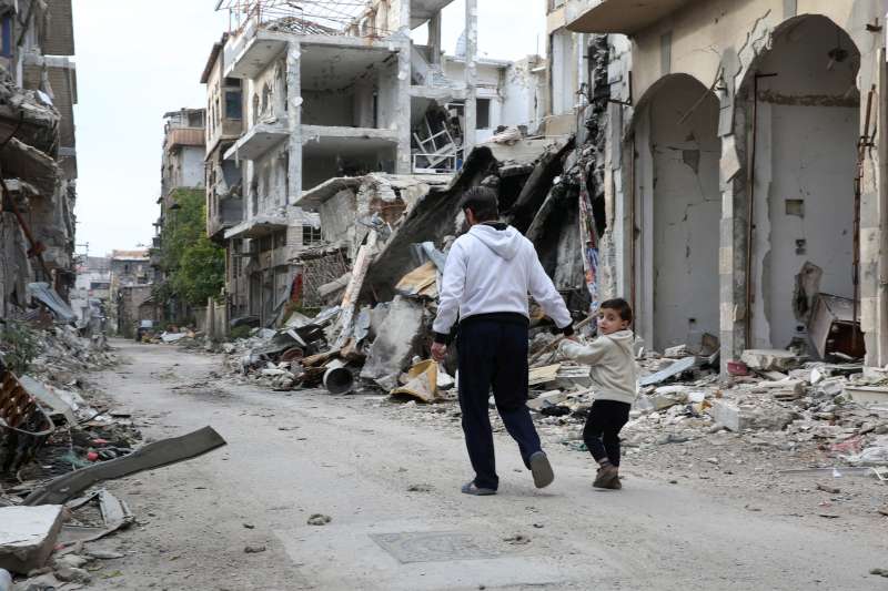 A father and son walk through the ruins of their home town of [&hellip;]