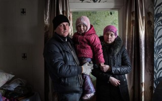 Katia, Sergei and daughter Sofia, 3, at home in Nikishino, eastern Ukraine. UNHCR/Andrew McConnell