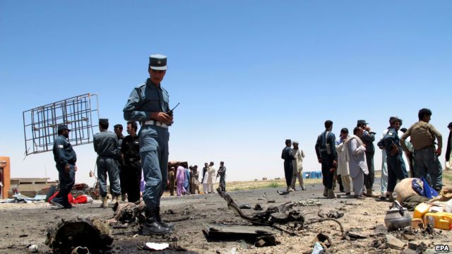 Afghan security officials inspect the site of a suicide bomb blast that targeted a security convoy in Lashkar Gah, in Helmand Province, on July 21.