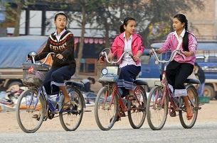 Lao girls ride their bikes to school in Luang Prabang in a file photo.