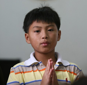 A Lao boy prays in a Christian church in Vientiane in a file photo.