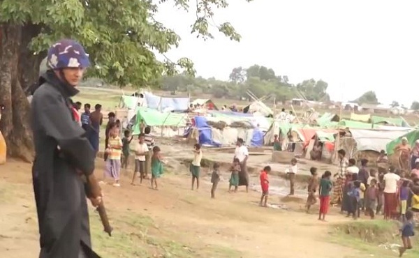 A security guard stands by a camp for displaced Rohingyas near the Rakhine state capital Sittwe on May 15, 2013.
