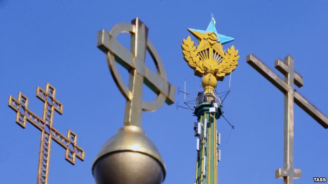 A Soviet red star atop a Stalin-era skyscraper was painted in the yellow-and-blue colors of the Ukrainian flag.