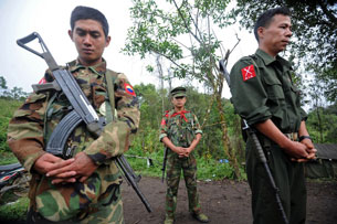 Kachin Independence Army soldiers pray before taking their positions at a camp in Kachin state, Sept. 19, 2012.