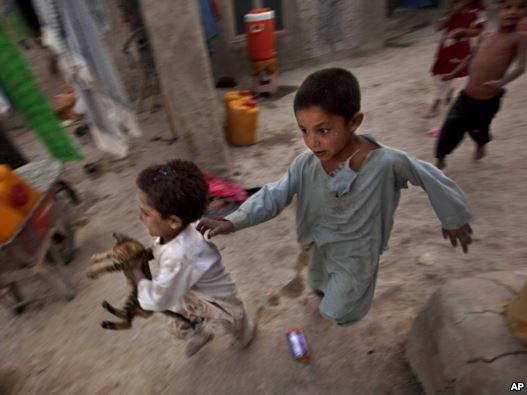 Internally displaced children play at a refugee camp in Kabul in early August.