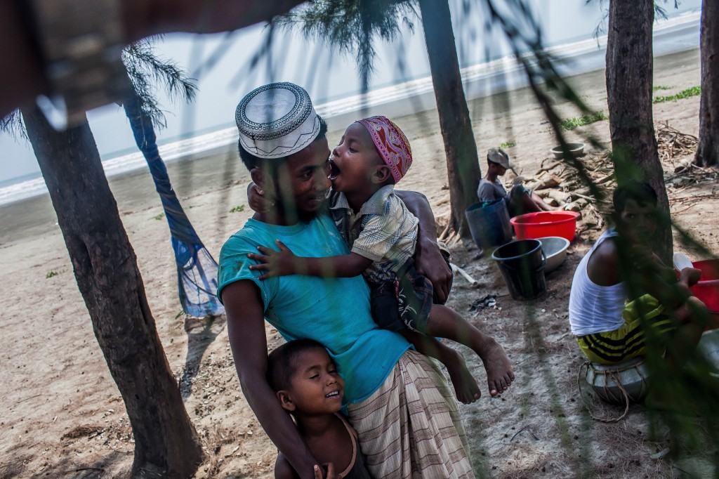 The children may not know it, but their father Yacoub is embarking on a journey he may never return from. He could face rough seas and violence at the hands of smugglers. If he is lucky, he will survive and find a low-paying job in the informal sector in Malaysia, from where he can send remittances back to his family. Photo by UNHCR/S.H. Omi/2014