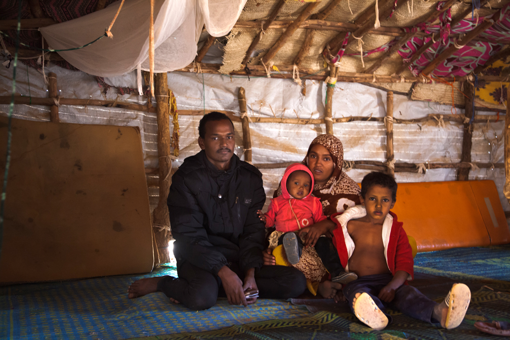Jafar poses with his wife Zeinabou, their baby daughter Fadimata and they nephew Sidi in their shelter in Mentao refugee camp, Burkina Faso, only days before returning to their homes in Mali.  UNHCR / Paul ABSALON