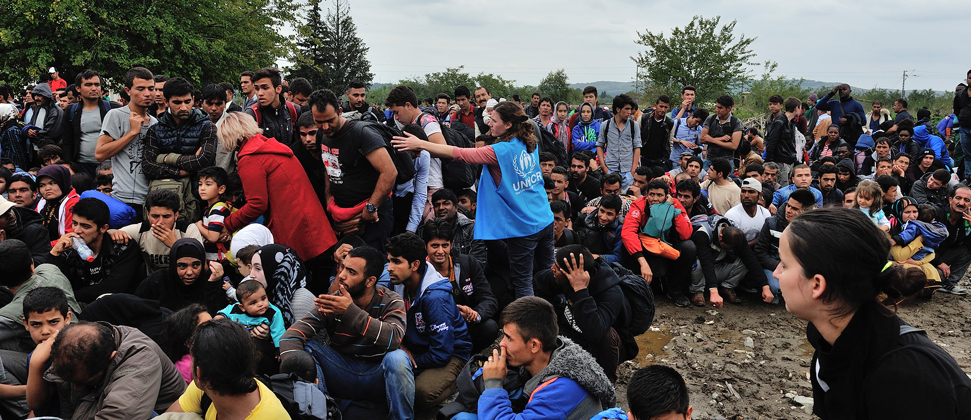 Refugees being asked by Alexandra Krause UNHCR Senior Emergency Coordinator to be patient and sit down while waiting to enter Vinojug reception centre at Gevgelija. More than 10,000 refugees passed through the centre in FYROM in one day.