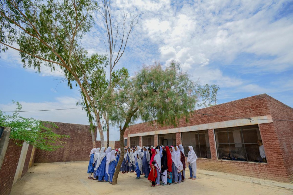 Young Afghan refugees and Pakistani girls attend assembly at Aqeela Asifi's school. Today 1,500 young people are enrolled in six schools throughout the refugee village.