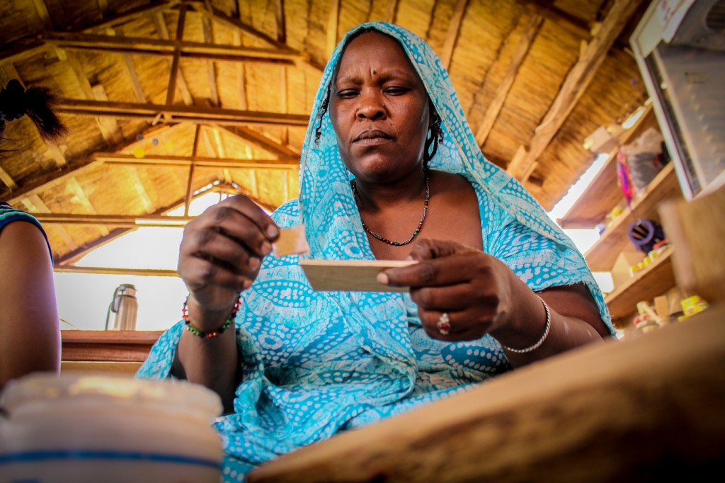 A Malian refugee woman learns to design and make quality products at a workshop in Ougadougou, Burkina Faso