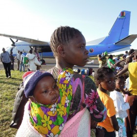 Young Angolan refugee woman with a child