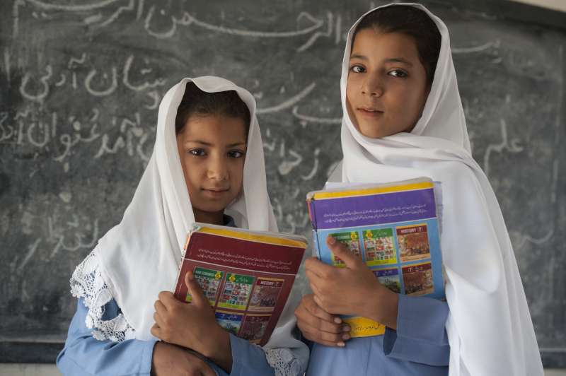 Haseena, nine years old, left, and Nadia, twelve years old.  The sisters are the second generation of Afghan refugee girls to attend Asifi's school. Their mother, Salma, was among the first girl students two decades ago.  