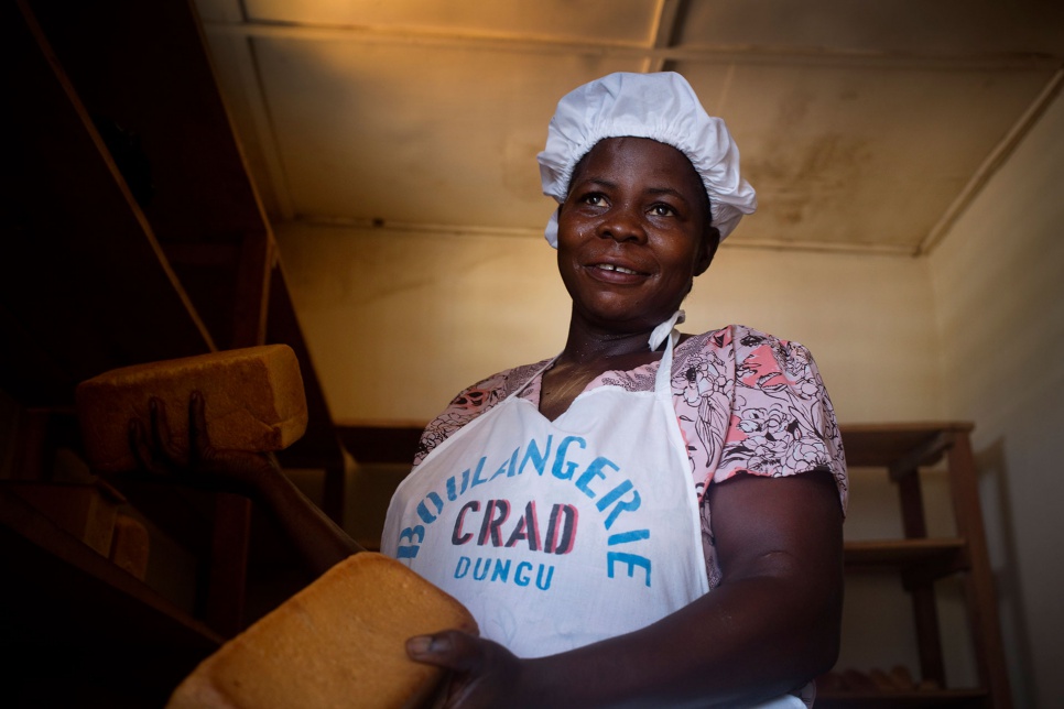 Pascaline gets to work at the new bakery in Dungu, in eastern Congo.