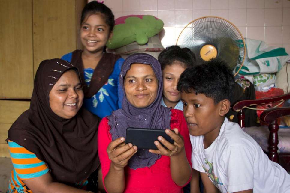 Rohima (centre) Skypes with her son Ali and daughter Shahida in Aceh, Indonesia. Her younger son, 10, looks on.