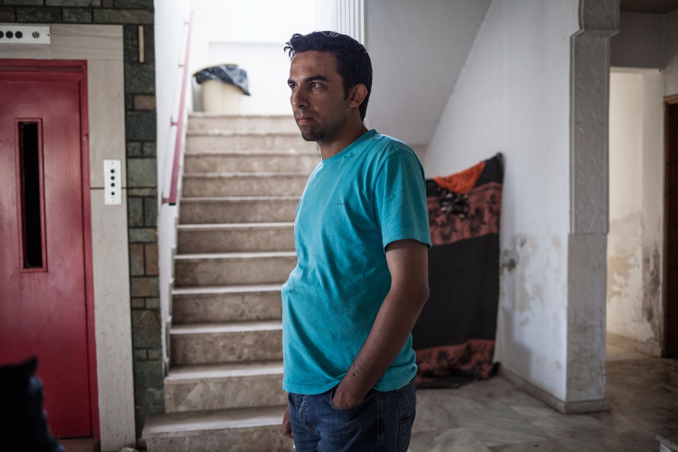 Ali stands inside the Captain Elias hotel in Kos, Greece. Hundreds of refugees have found temporary shelter at the former hotel.