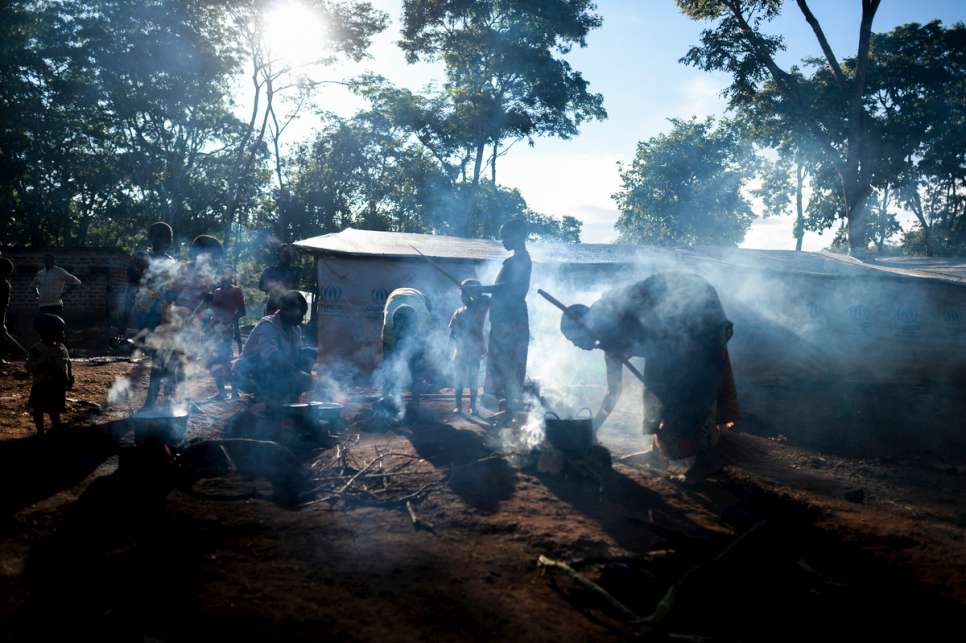Women cook in the morning outside their tents in Nduta refugee camp.
