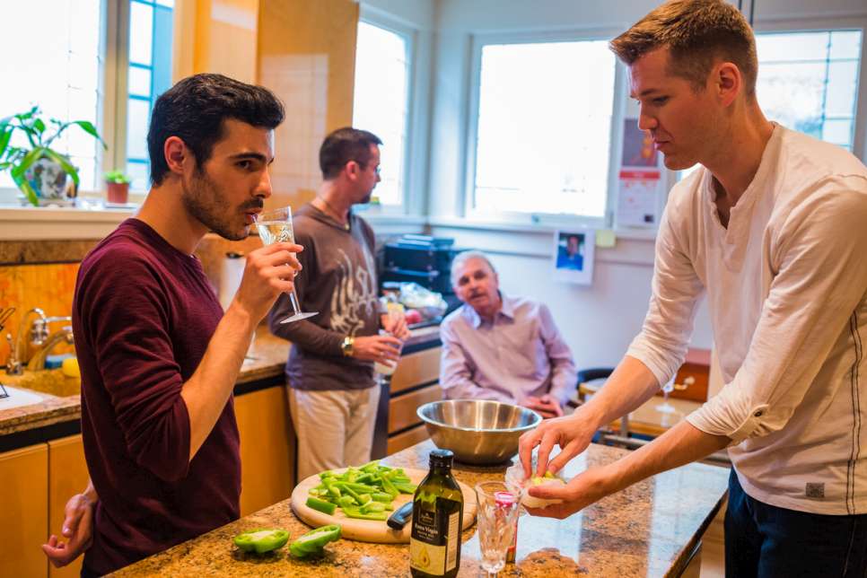 Subhi Nahas, a Syrian refugee, and his American partner, Mark Averett, help prepare food at a friend's dinner party.

