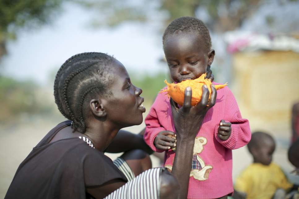After seven days on the run, young Nyanchau, who is internally displaced, chews on the dry flesh of a palm nut in Rumbek, South Sudan.