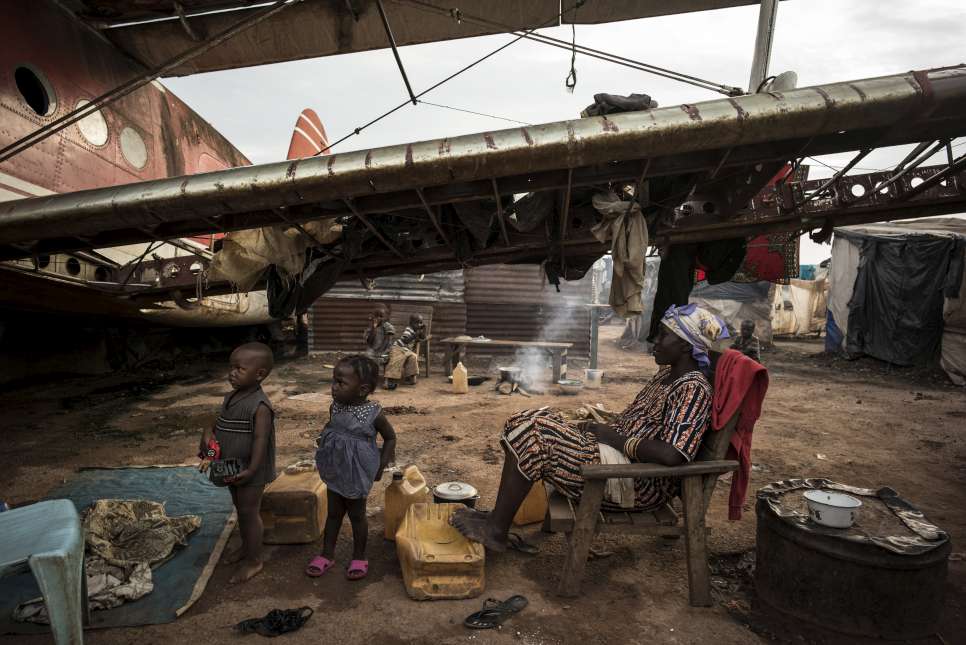 Displaced people live beneath a decommissioned airplane near the international airport in Bangui, Central African Republic.