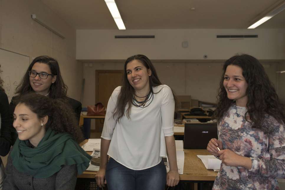 Alaa listens as a fellow student presents his designs in an afternoon class in Lisbon.