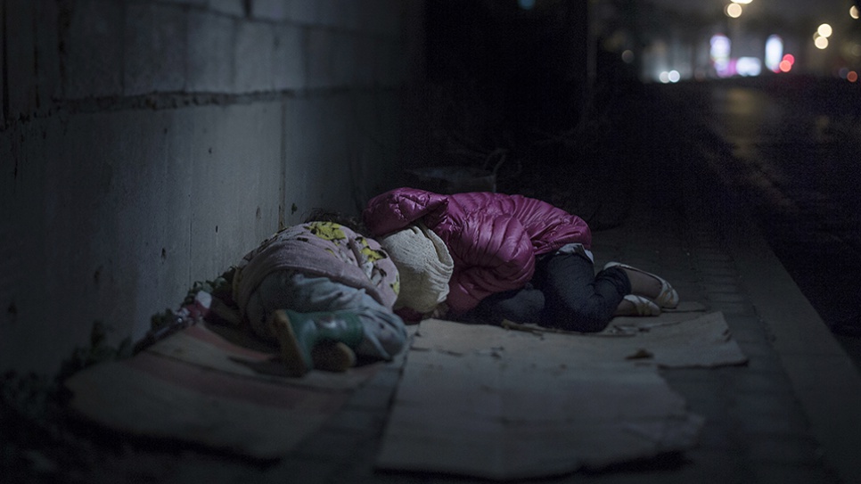 Ralia and Rahaf live on the streets of Beirut. They are from Damascus, where a grenade killed their mother and brother. The girls and their father have been sleeping on the street for a year. They huddle close together on their cardboard boxes. Rahaf says she is scared of "bad boys", at which Ralia starts crying.