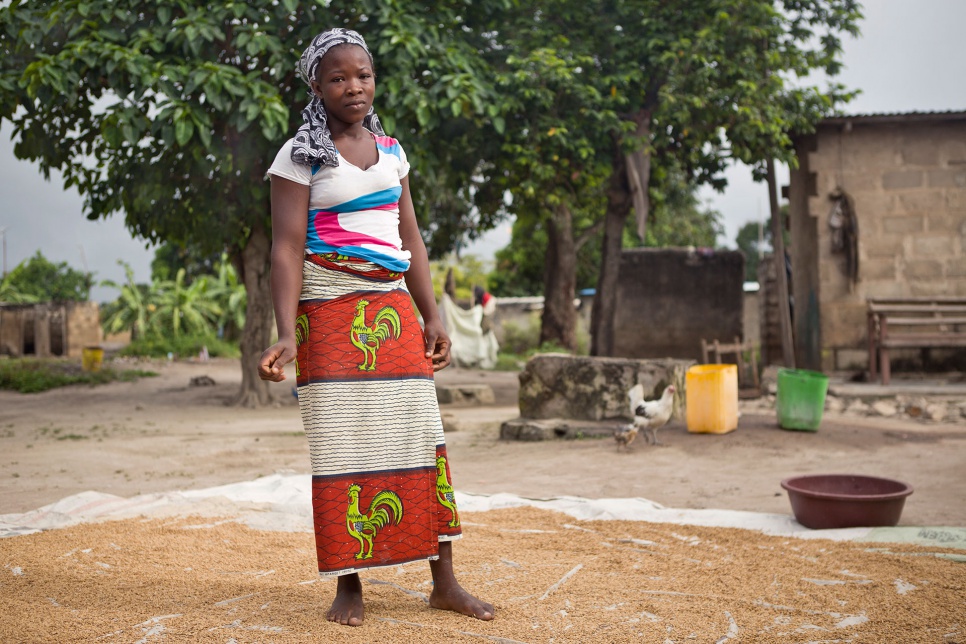 Rakiata's daughter, Lisette, 20, prepares millet for sale in Côte d'Ivoire. Lacking proof of her birth there, or of her ancestral ties to Burkina Faso, she is at risk of statelessness.