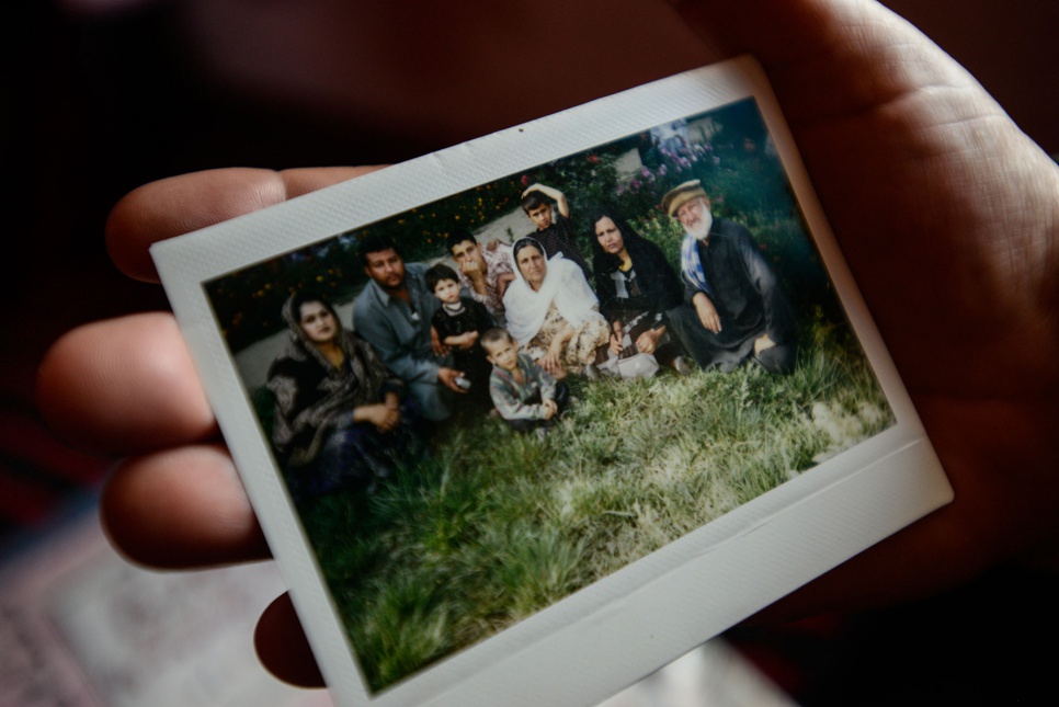 Asifi reminisces over an old family photo taken in Afghanistan. She misses her mother and the family she left behind in Kabul when she was forced to flee in 1992.