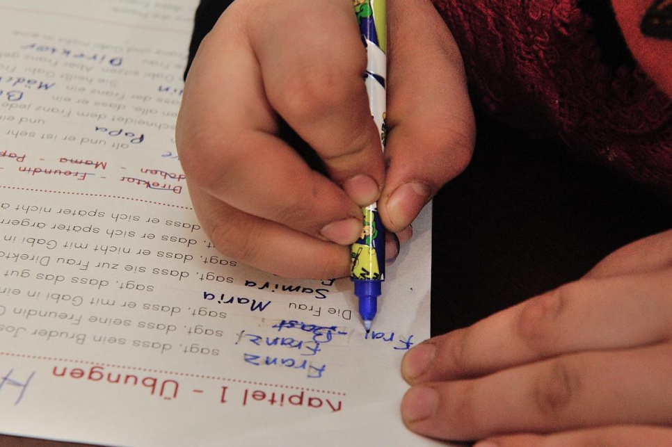 Samira does her German homework in the family's new home.