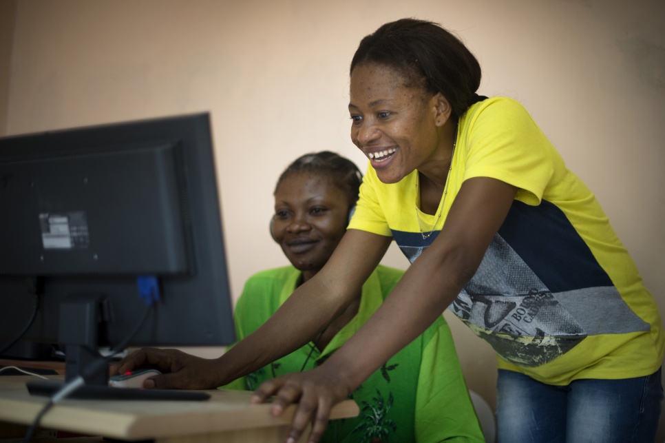 Budiaki, 32, helps a student to connect with family online during one of the basic computer skills training sessions that she runs at a Women's Centre for urban refugees in Nouakchott, Mauritania.
Originally from the Democratic Republic of the Congo, Budiaki has been displaced by conflict multiple times in her life.
"I was at school when [a group of armed men] came," she recalls. "I rushed back home to my uncle's place, only to find out that the house had already been taken by the soldiers."
Today, she is a qualified trainer who runs classes three times a week and acts a representative for refugee women living in Nouakchott.
"I know what it feels like when you don't know where your relatives are, and how important it is to communicate with them," she explains. "That's why I chose to be an information technology trainer and help more people find their families."
