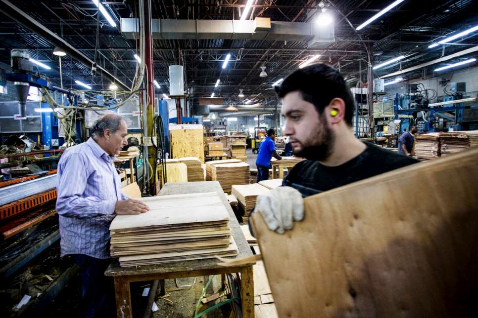 Kevork (right) and Aram Nigoghosian work together in the pressing department at the Seatply factory.