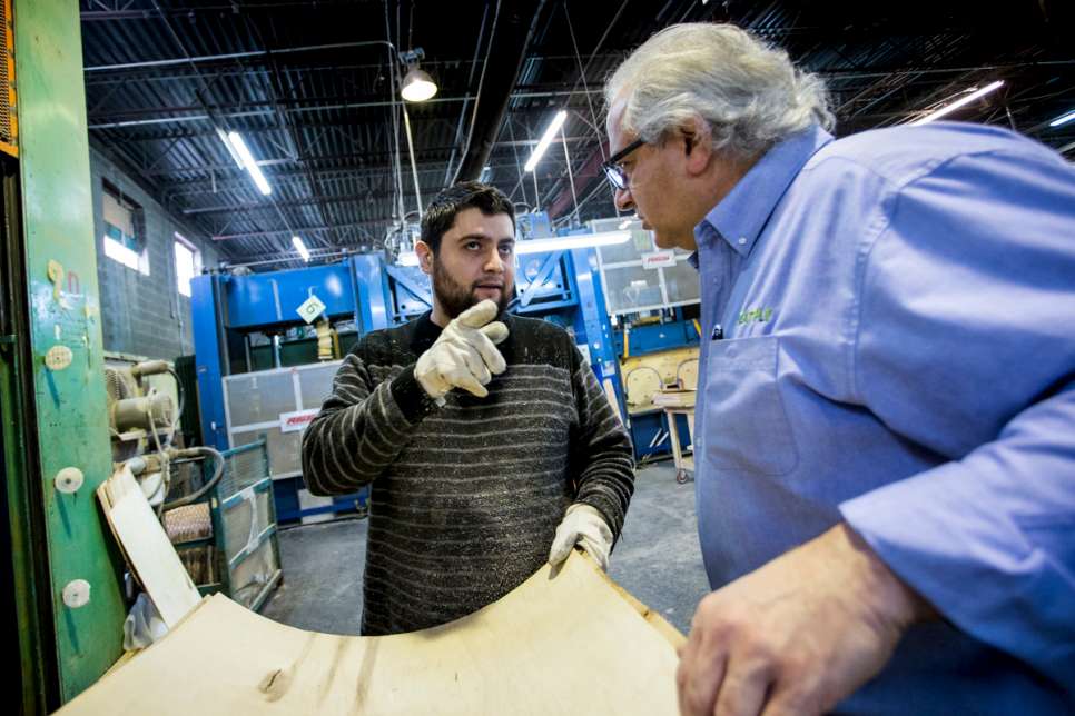 Kevork talks with Levon Afeyan at the Seatply factory in Quebec. Levon, who owns the company, fled Lebanon's civil war in 1975 with his family.