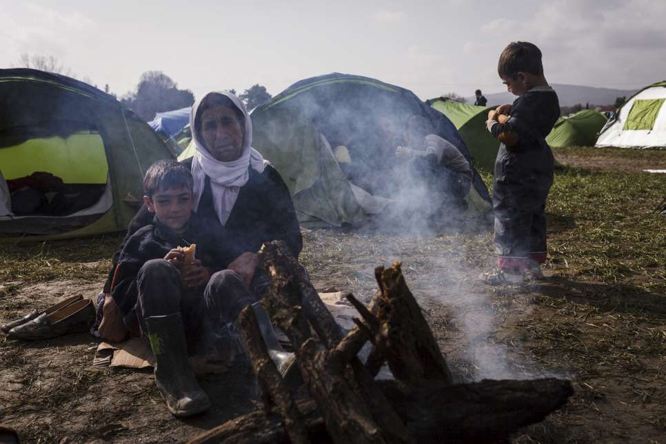 Barfi Halil, a Yazidi from Sinjar in Iraq, sits beside a fire with her grandchildren. The 63-year-old grandmother has spent the past week in the fields of Idomeni, sharing a small camping tent with her son, his wife and their five children, one of whom has severe developmental disabilities.

The family fled Sinjar in 2014, after militants laid siege to the area. They first went to a camp for displaced people outside Dohuk, in the Kurdistan region of northern Iraq. They then sought safety in Europe. The family worries that new border restrictions will prevent them from crossing the border into the Former Yugoslav Republic of Macedonia.

"We Yazidis have suffered a lot," Barfi said. "We can't go back home."