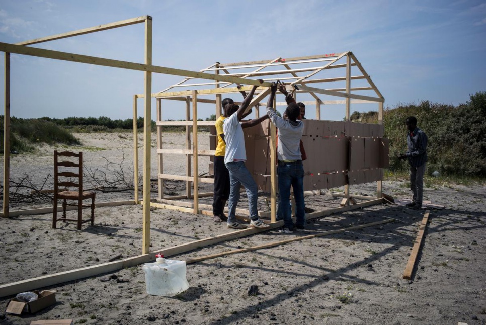 Sudanese migrants build a shelter in the so-called 'Jungle' in northern France, where winds can reach high speeds.