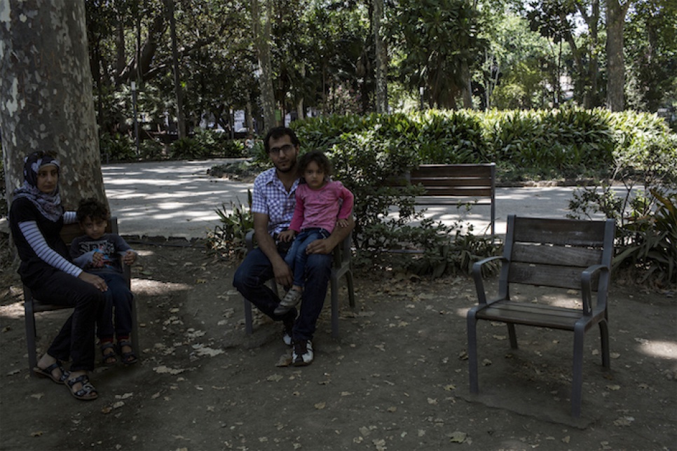 Mohammed and his family, who escaped the war in Syria, take a break in the shade at Villa Bellini in Catania, Italy.
