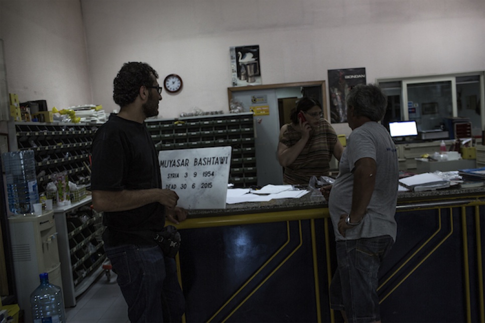 Mohammed, a Syrian refugee, buys a headstone for his mother-in-law's grave at a shop in Catania, Italy.