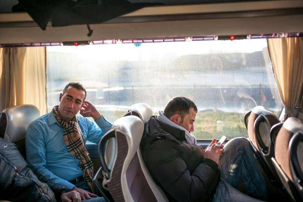 Salaman (left) and Bewar from Iraq relax during the 10-hour bus journey. 