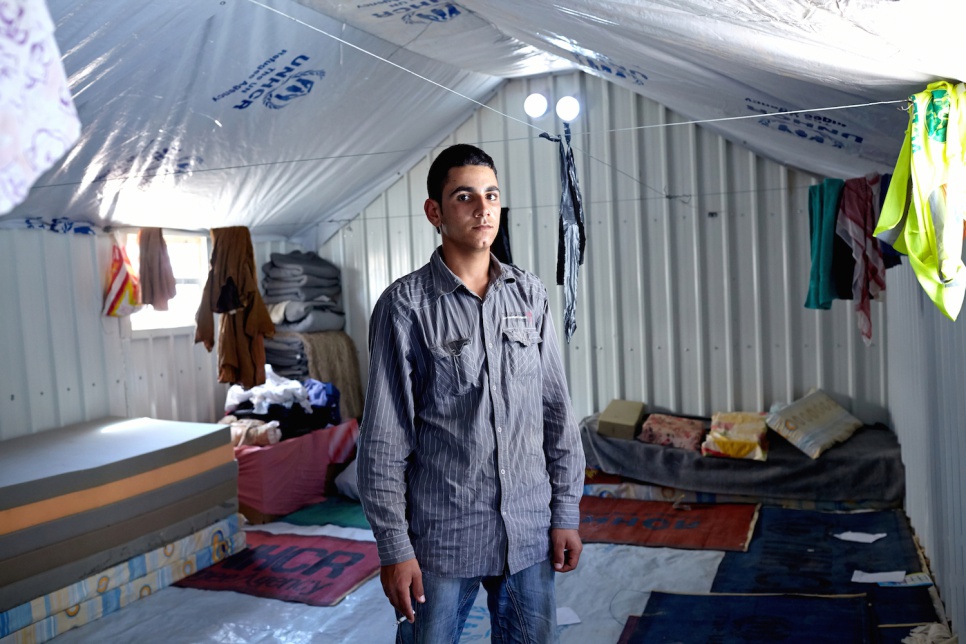 Amer, 20, inside his family's shelter at Azraq camp. "With outside light we could gather more easily and talk with friends and family. Being able to socialize helps you feel better."