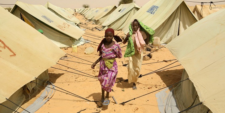 Chad / Refugee girls from Sudan's Darfur region walk through the tents' alleys in Kounoungou camp, eastern Chad. UNHCR just tranfered them and their families from the Birak area, located only 5 kms away from the border with Sudan. An estimated 13,000 people arrived in eastern Chad throughout the month of February escaping aerial bombings and ground attacks by janjaweed. The first attacks started on February 8th in Seliah, Sirba and Abu Suruj, north of El Geneina, the capital of West Darfur. Additionnal attacks also took place later that month in the Jebel Moon area.  Thousands of people  found refugee across the border in Chad in the Birak area around 11 villages including in Seneit, Figuera, Bagar Katala, Djatak, Himera.  Kounoungou camp, March 13, 2008. / UNHCR / H. Caux