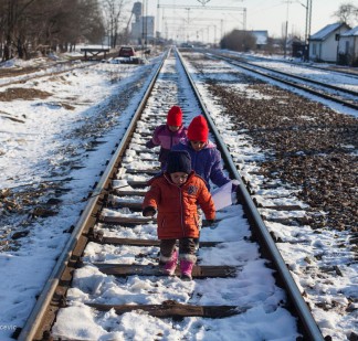 Group of kids playing around on the train station at the town of Presevo, Serbia.