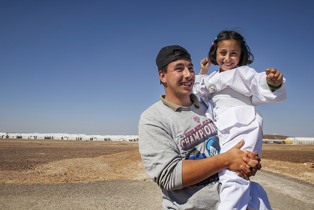 Jordan. Nine-year-old Syrian refugee, Solaf, with her brother Munaf, 21, at Azraq refugee camp