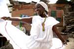 Maribeth dances outside her house in Soacha, Colombia. "My spirit is free when I dance and I am in another world".