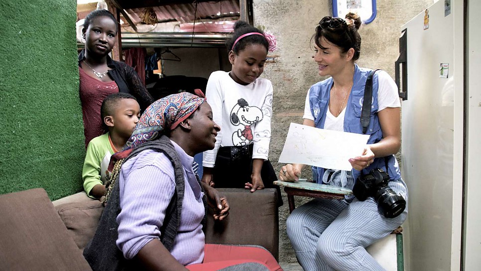 Maribeth and the family look at Marilyn's homework with Helena.